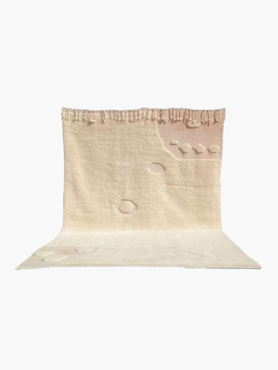 A beige wool rug with a textured pattern.