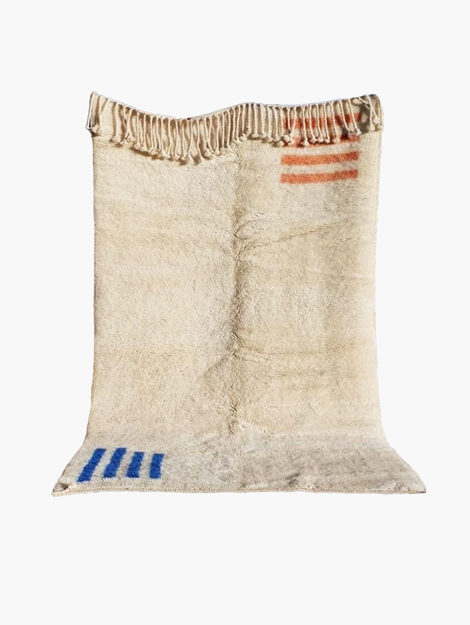 A natural wool area rug with geometric patterns in blue and coral on the edges.